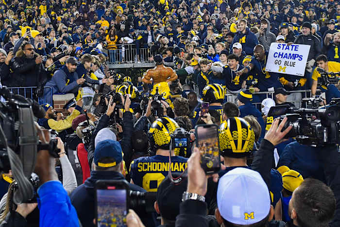 Players cram into the only tunnel at Michigan Stadium after the Wolverines win against MSU.